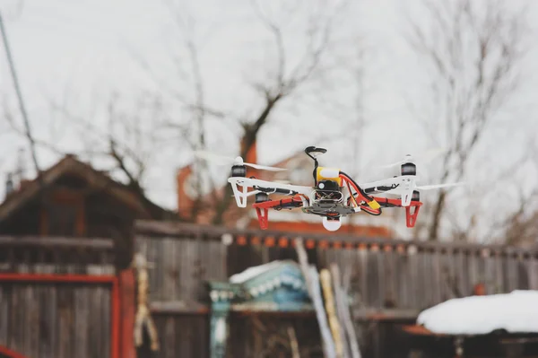 Drone in aerial flight on countryside. Modern technologies for capturing photo and video. Winter day.