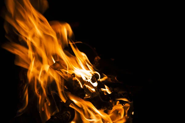 Fire flames on a black background. Blaze fire flame texture back