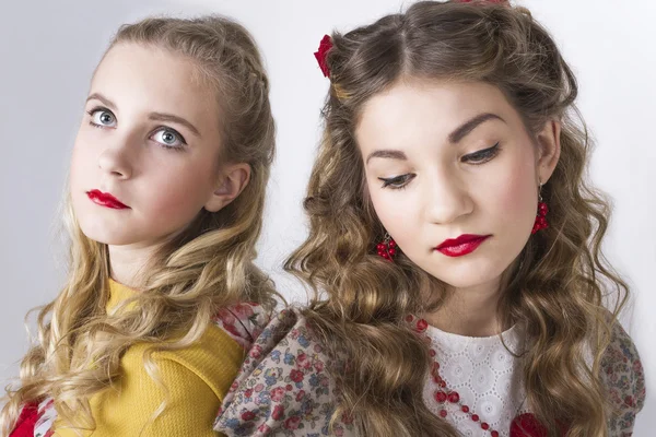 Portrait of two young beautiful girls in the Russian style