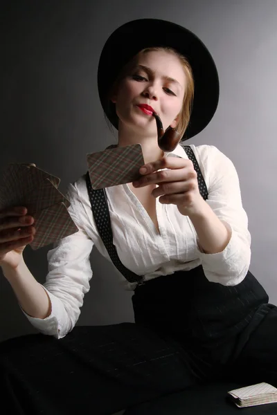 The beautiful unusual attractive girl with playing cards