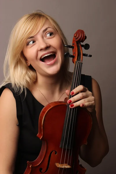 Portrait of the nice fair-haired girl with a violin