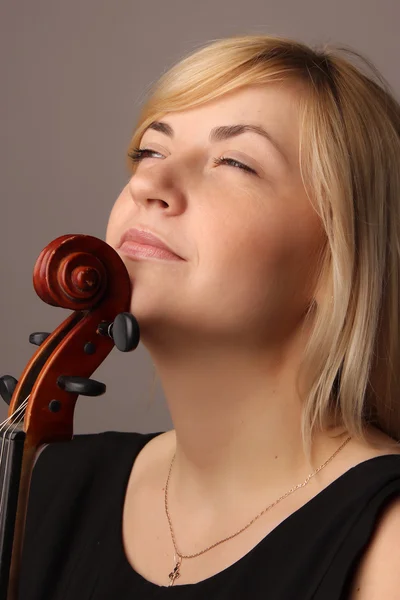 Portrait of the nice fair-haired girl with a violin