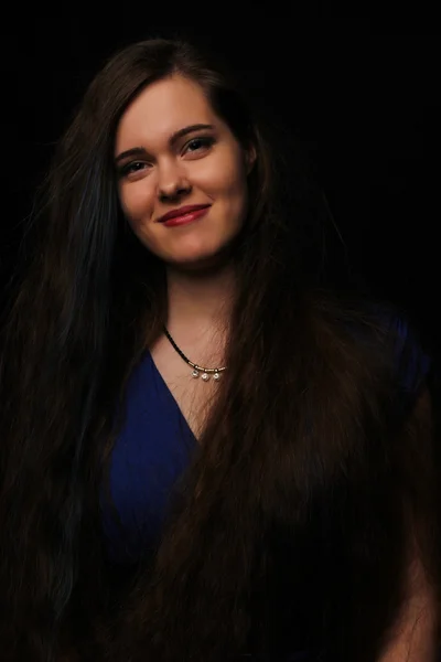 Portrait of the beautiful young girl with long dark hair