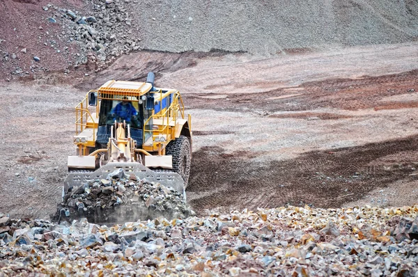 Earth mover loading rocks in a quarry