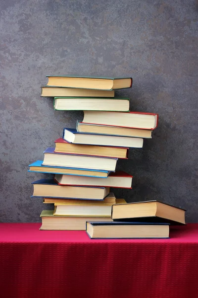 The stack of books  on the table