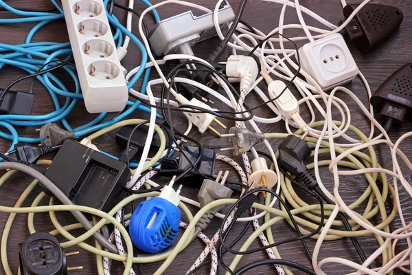 Electric wires, cables, charger on the floor, top view.