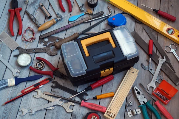 Tool box on wooden floor, view from above.