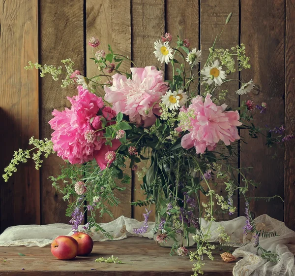 Still life with a bouquet of peonies.