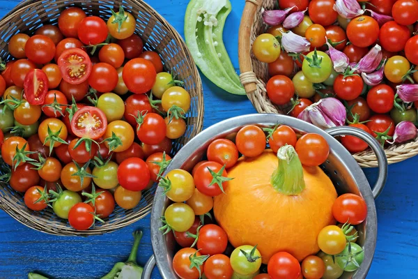 Red and yellow cherry tomatoes, pepper, pumpkin and garlic