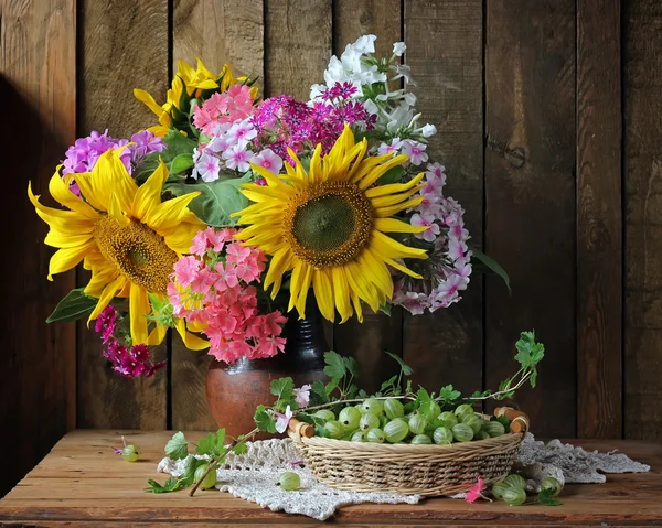Still life with a bouquet of sunflowers and phloxes