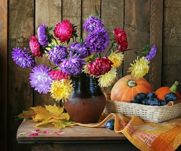 Still life with a bouquet from asters and chrysanthemums