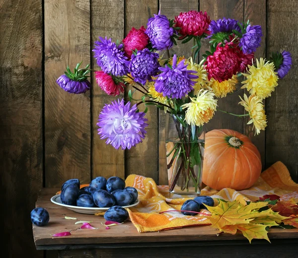 Still life with asters and plums.