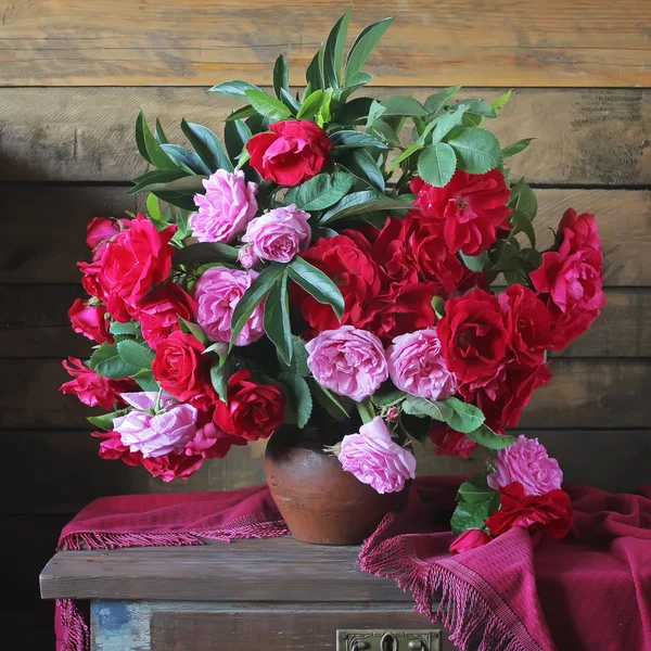 Still life with red and pink garden roses.