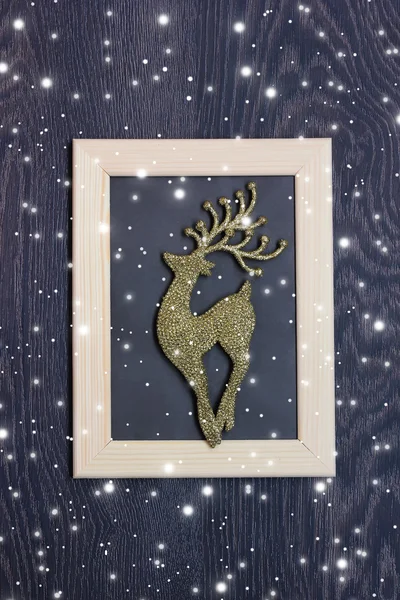 New Year\'s background: a deer of gold color in a photoframe on a