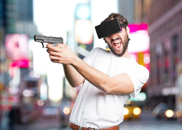 Young man with pistol and virtual glasses