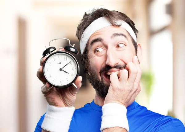 Crazy sports man with alarm clock