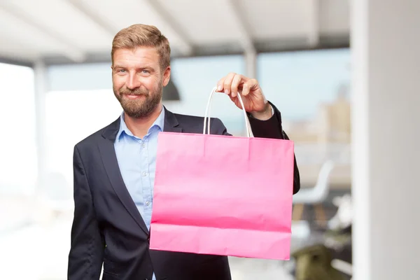 Blond businessman with shopping bag