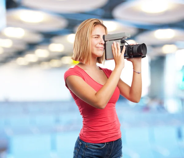 Young blond girl with retro camera