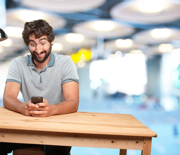 Man sitting at table with mobile phone