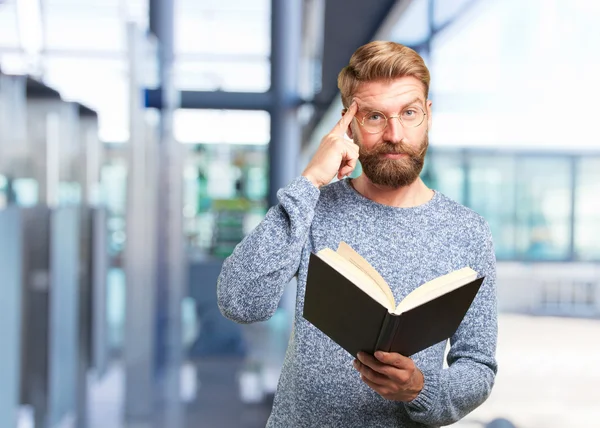 Blond hipster man with a book