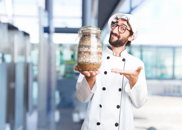 Crazy chef with a jar with ingredients