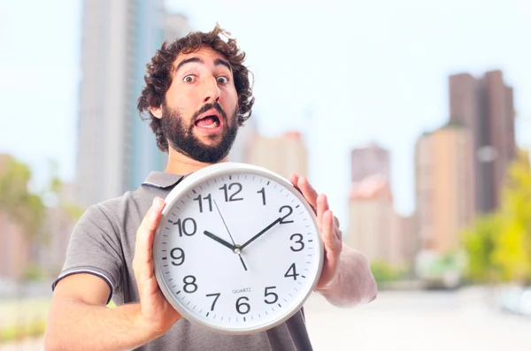 Young crazy man worried with a clock