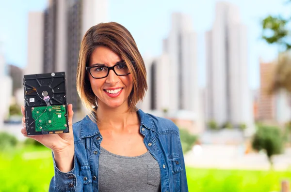 Young cool woman with broken hard disk