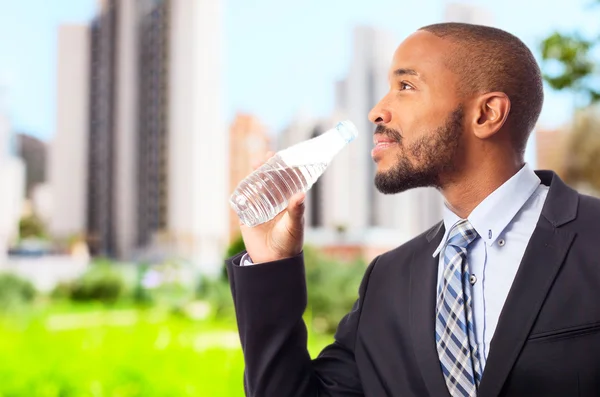 Young cool black man drinking water