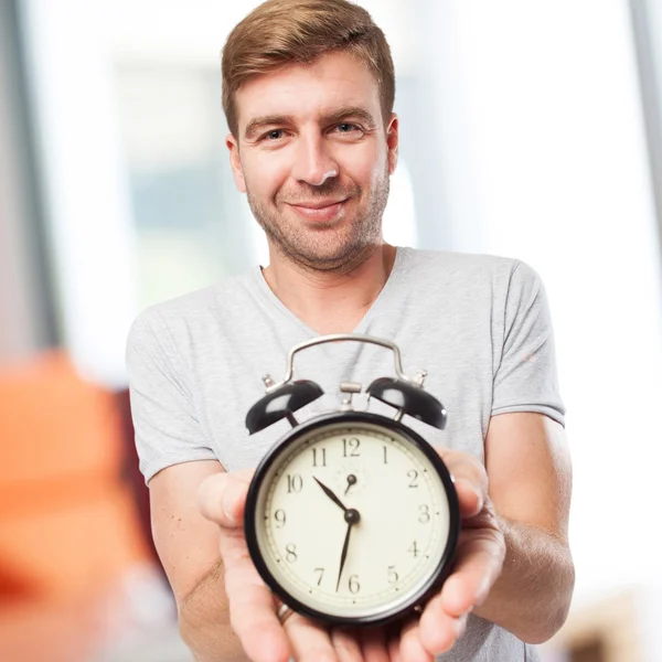 Blond man with a clock