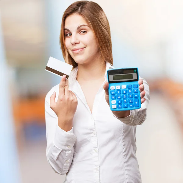 Blond woman with calculator and credit card