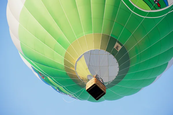 People fly in hot air balloon over the old town in Vilnius, Lithuania.