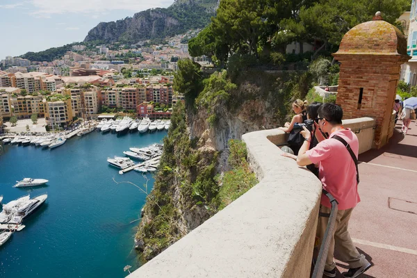 People take photos of the Fontvieille and Monaco Harbor in Monaco.