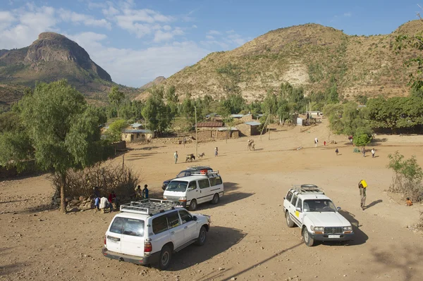 Tourist\'s cars parked at the entrance to a small village in Adwa, Ethiopia.