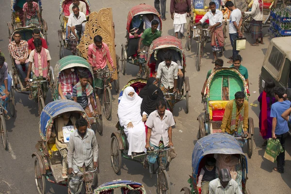 Rickshaws transport passengers in Dhaka, Bangladesh.