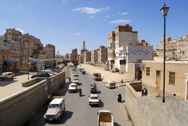 People walk by the street of Sanaa city in Sanaa, Yemen.