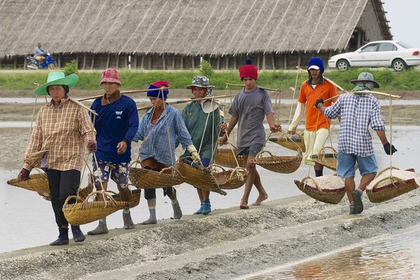 People work at the salt farm in Huahin, Thailand.