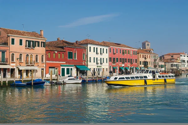 Public transportation boat passes by the Grand canal in Murano, Italy.