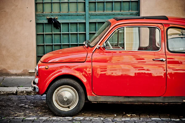 ROME, ITALY - APRIL, 25: Retro small red Italian car Fiat 500 at the street of Rome, April 25, 2013