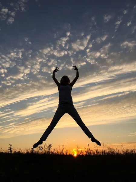 Girl at sunset jumping at sunset.