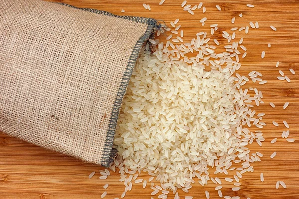 Parboiled rice spilling out of burlap bag