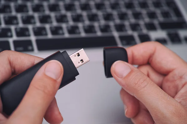 Hands opening USB Flash Drive