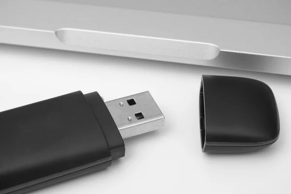 USB Flash Drive with laptop in the background