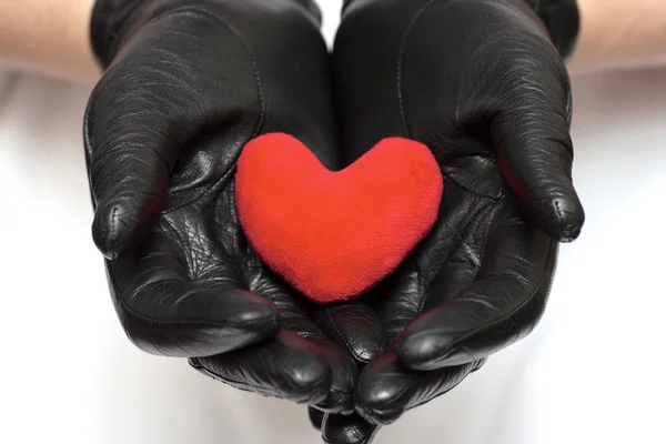 Heart in hands with gloves