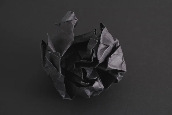 Crumpled black paper ball