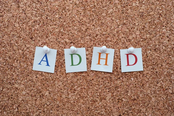 ADHD letters pinned to a cork notice board
