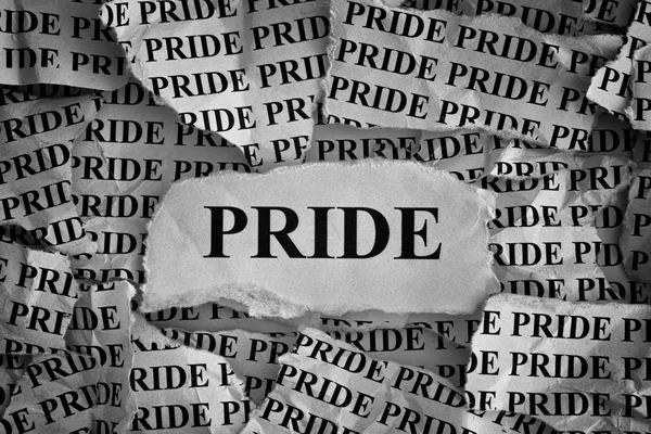 Torn pieces of paper with the word Pride