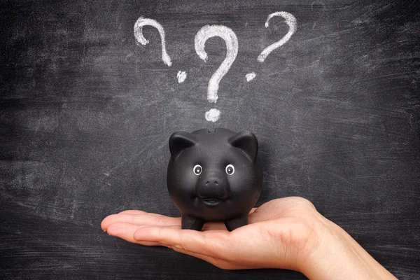 Piggy bank and question marks