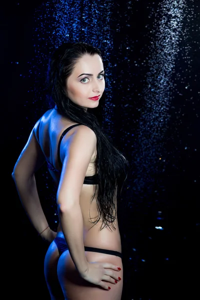 Sexy woman black blue aqua studio rain shower