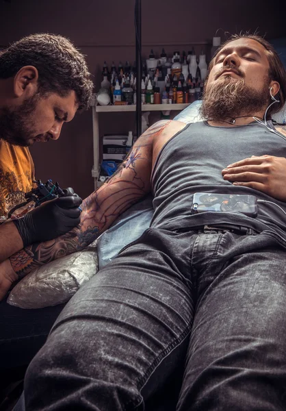 Tattoo specialist posing in tattoo studio