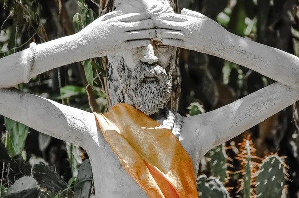 Asian statue close eyes by hands